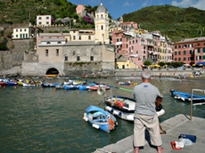 Angler looking at the church of Vernazza in the Cinque Terre